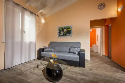 a living room with a couch and a glass table at Villa Gea in Castellammare del Golfo
