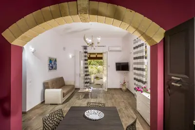 a living room with a couch and a table at Villa Gea in Castellammare del Golfo