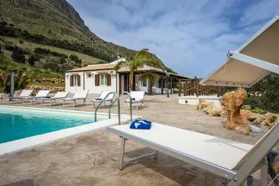 a villa with a swimming pool and a resort at Villa Gea in Castellammare del Golfo