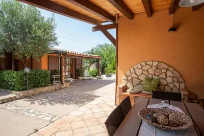 a patio of a house with a stone fireplace at Villa Isabella in Castellammare del Golfo