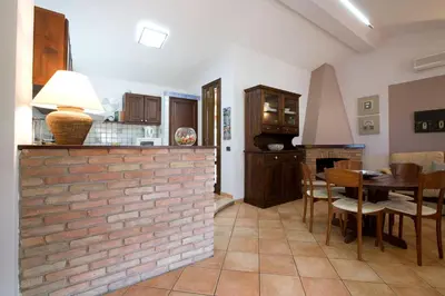 a kitchen and dining room with a brick wall at Villa Isabella in Castellammare del Golfo