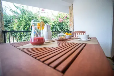 a wooden table with a drink on top of it at Villa La Randa in Castellammare del Golfo