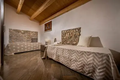 a bedroom with a bed and a couch in it at Villa Thalia in Castellammare del Golfo