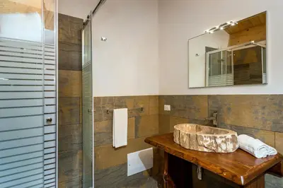 a bathroom with a sink and a glass shower at Villa Thalia in Castellammare del Golfo