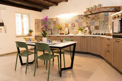 a kitchen with a table and chairs in it at VILLA ROSETTA ampi spazi esterni WIFI FREE in Trabia