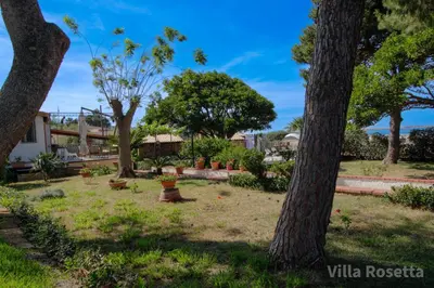 a park with trees and flowers in the grass at VILLA ROSETTA ampi spazi esterni WIFI FREE in Trabia