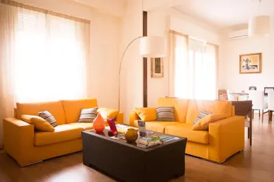 a living room with two orange couches and a table at Residenza Wagner in Palermo