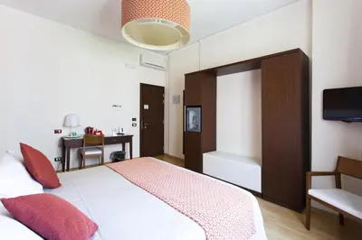 a bedroom with a large bed with red pillows at Residenza Wagner in Palermo