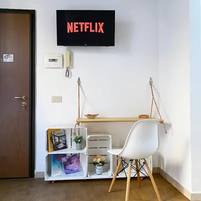a desk and a white chair in a room at Marilù in Palermo