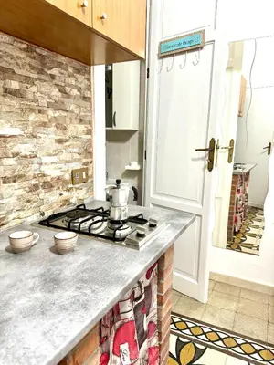 a kitchen with a stove top oven next to a door at Marilù in Palermo