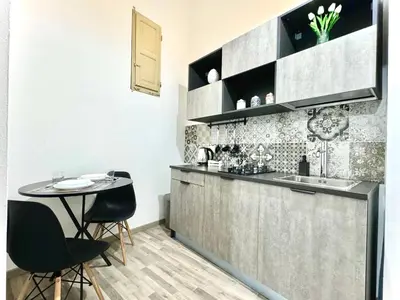 a kitchen with a table and chairs and a counter at Marilù in Palermo