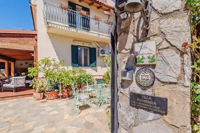 a house with a sign on the side of it at Villa Ficodindia in Altavilla Milicia