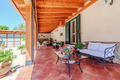 a patio with a couch and a table at Villa Ficodindia in Altavilla Milicia