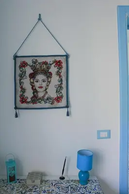 a picture of a woman on the wall in a room at Narciso Blu in Castellammare del Golfo