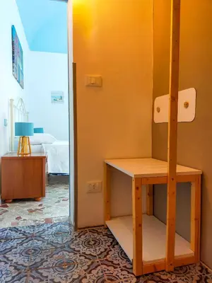 a room with a desk and a room with a bed at Narciso Blu in Castellammare del Golfo