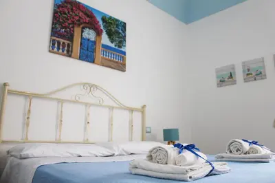 a bedroom with a bed with towels on it at Narciso Blu in Castellammare del Golfo