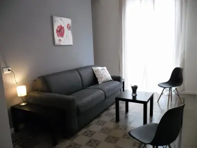 a living room with a couch and a table at Le vie del Centro in Palermo