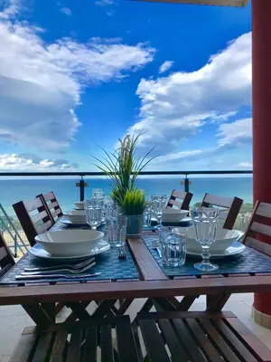 a wooden table with a view of the ocean at Red Luxury in Borgo Guardiola near Cefalù in Mandra Capreria