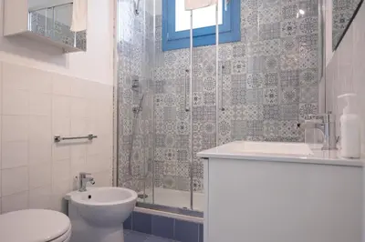 a bathroom with a shower and a toilet and a sink at Casa Azzurra sul mare e centralissima in San Vito lo Capo