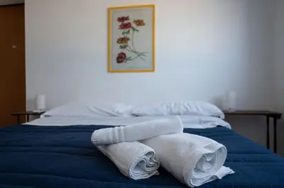 a bed with towels sitting on top of it at Casa Blu sul mare e centralissima in San Vito lo Capo