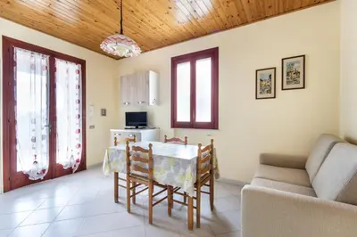 a patio with chairs and a table on a house at Residence le Coccinelle vicino a Cefalù in Campofelice di Roccella