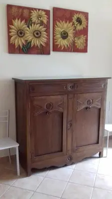 a wooden cabinet with two pictures on the wall at Suites Mondello Deluxe in Mondello