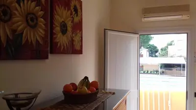 a bowl of fruit on a counter next to a door at Suites Mondello Deluxe in Mondello