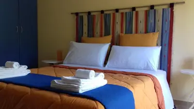 a bedroom with a large bed with towels on it at Suites Mondello Deluxe in Mondello