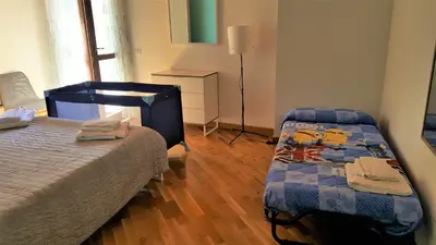 a bedroom with two beds and a lamp in it at Cocciu d'amuri Central Apartment Spacious and Comfortable in Palermo