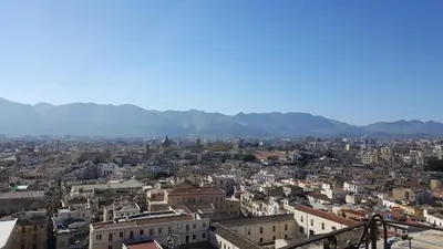 a view of a city with mountains in the background at Cocciu d'amuri Central Apartment Spacious and Comfortable in Palermo