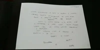 a piece of paper with a handwritten letter at B&B Orchidea in Palermo