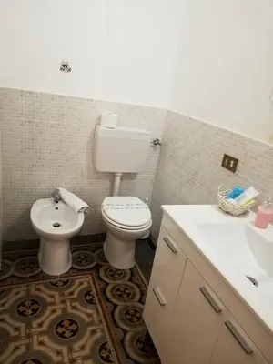 a bathroom with a toilet and a sink at B&B Orchidea in Palermo