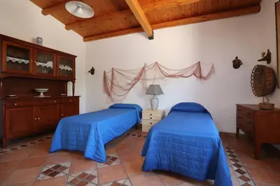 two beds in a room with wooden ceilings at EVEN HAVEN Baglio in San Vito lo Capo