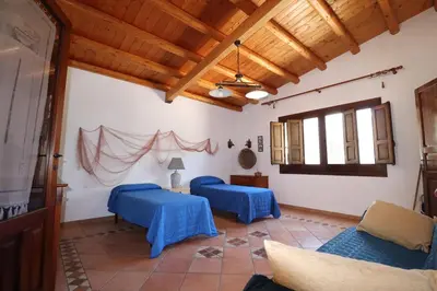 a living room with blue tables and wooden ceilings at EVEN HAVEN Baglio in San Vito lo Capo