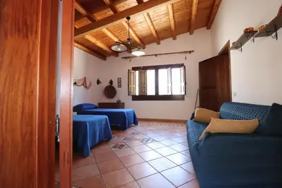a living room with two tables and a couch at EVEN HAVEN Baglio in San Vito lo Capo