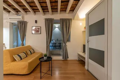 a living room with a couch and a television at Casa Abbanniata a Ballaro' by Wonderful Italy in Palermo