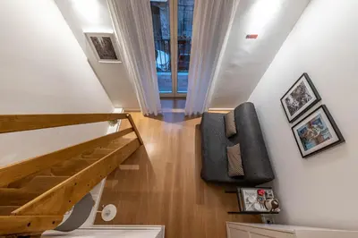 a staircase in a house with a chair and a stair case at Casa Abbanniata a Ballaro' by Wonderful Italy in Palermo