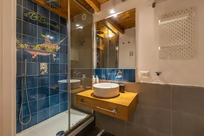 a bathroom with a sink and a glass shower at Casa Abbanniata a Ballaro' by Wonderful Italy in Palermo