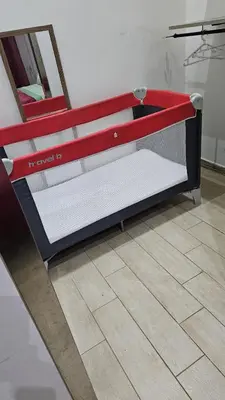 a bed with a red frame on top of a room at All'Ombra di Porta Nuova in Palermo