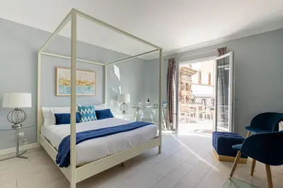 a bedroom with a canopy bed and a patio at I Mori di Porta Nuova Suite & Terrace in Palermo