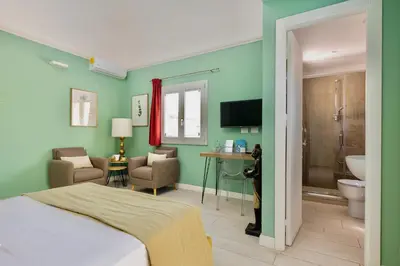 a hotel room with a bed and a bathroom at I Mori di Porta Nuova Suite & Terrace in Palermo