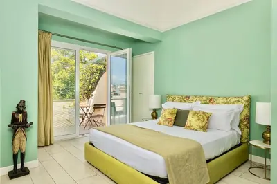 a bedroom with a large bed and a balcony at I Mori di Porta Nuova Suite & Terrace in Palermo