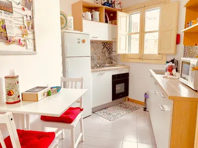 a kitchen with a white refrigerator and a table at Le terrazze segrete in Palermo