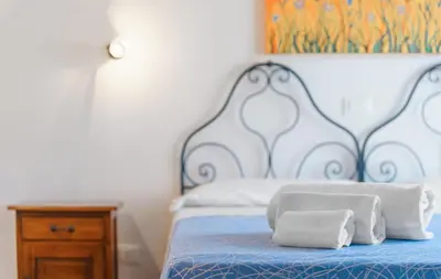 a bed with two towels sitting on top of it at Casale Ginisara in Castellammare del Golfo