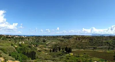 a view of a valley with trees and buildings at Casale Ginisara in Castellammare del Golfo