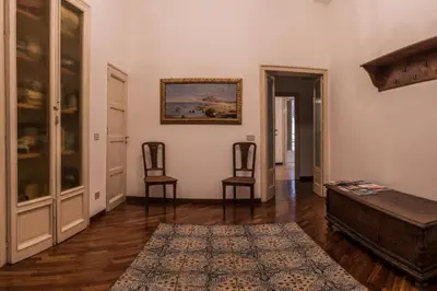 a living room with two chairs and a couch at Appartamento Palazzo Pace al Cassaro in Palermo