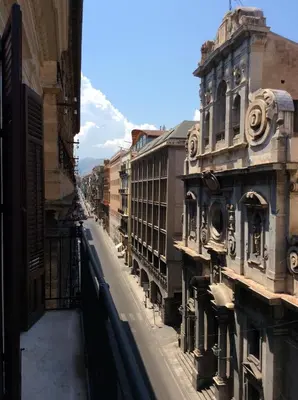 a view of a street in a city with buildings at Appartamento Palazzo Pace al Cassaro in Palermo