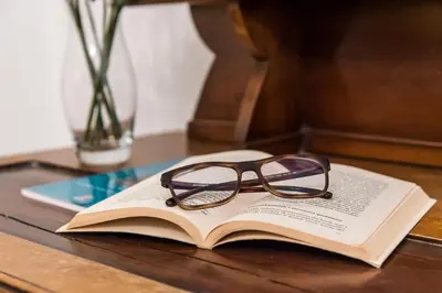 a pair of glasses sitting on top of a book at Appartamento Palazzo Pace al Cassaro in Palermo