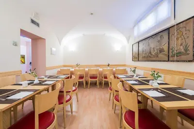 a dining room with long tables and chairs at Hotel Garibaldi in Palermo