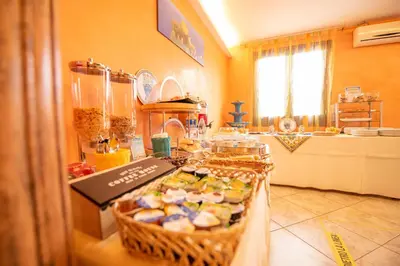 a kitchen with a table with a basket of food at Hotel Altamarea in San Vito lo Capo